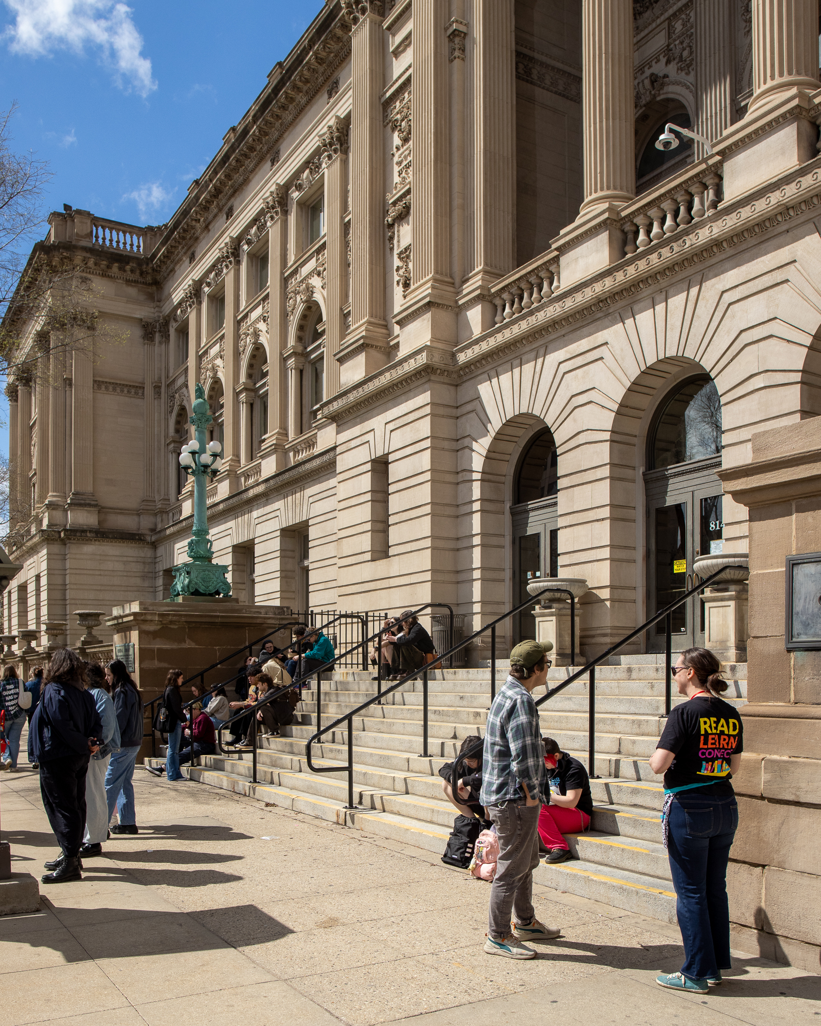 People gathered on the steps of Milwaukee Central Library for Zine Fest 2026